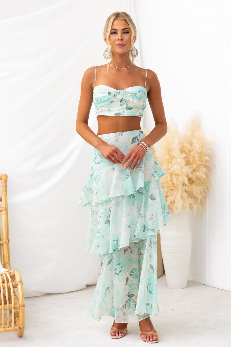Model wearing Saphina Top with floral print, adjustable straps, and layered chiffon skirt, showcasing a stylish summer look.
