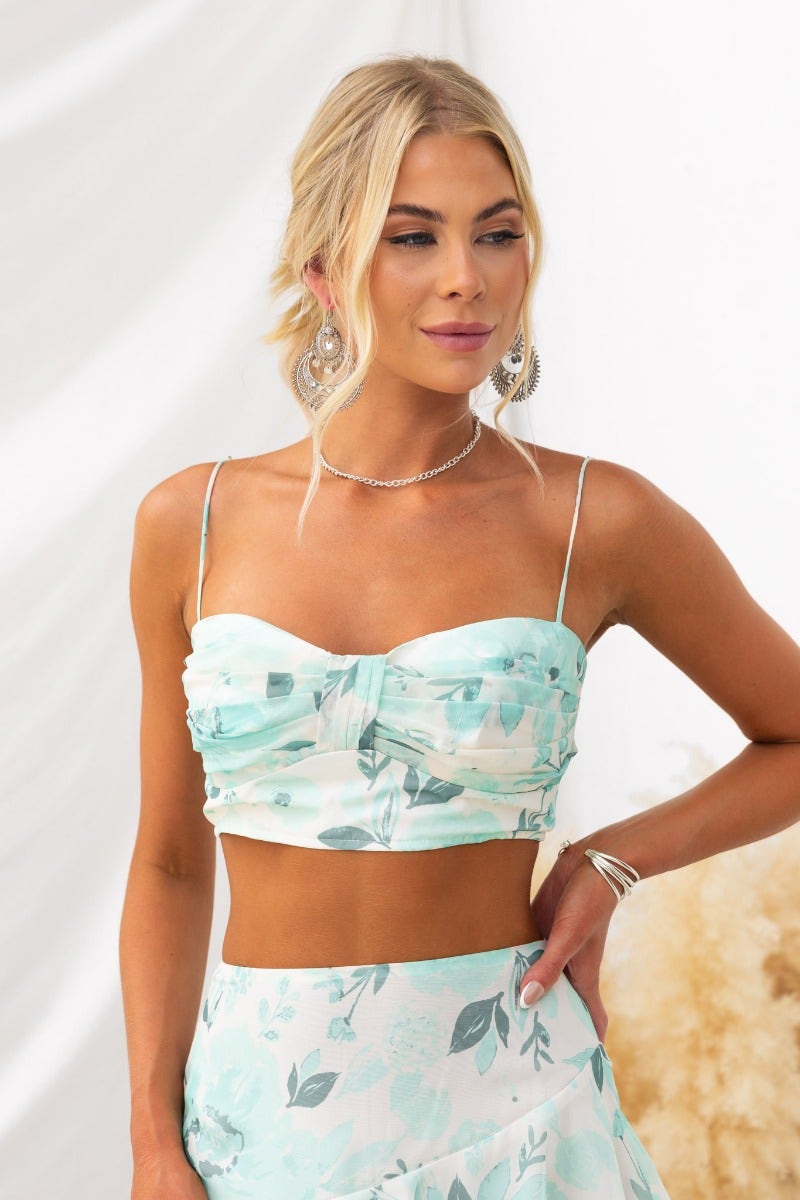 Saphina Top featuring floral print, adjustable straps, and back zip, styled with a matching skirt for summer elegance.