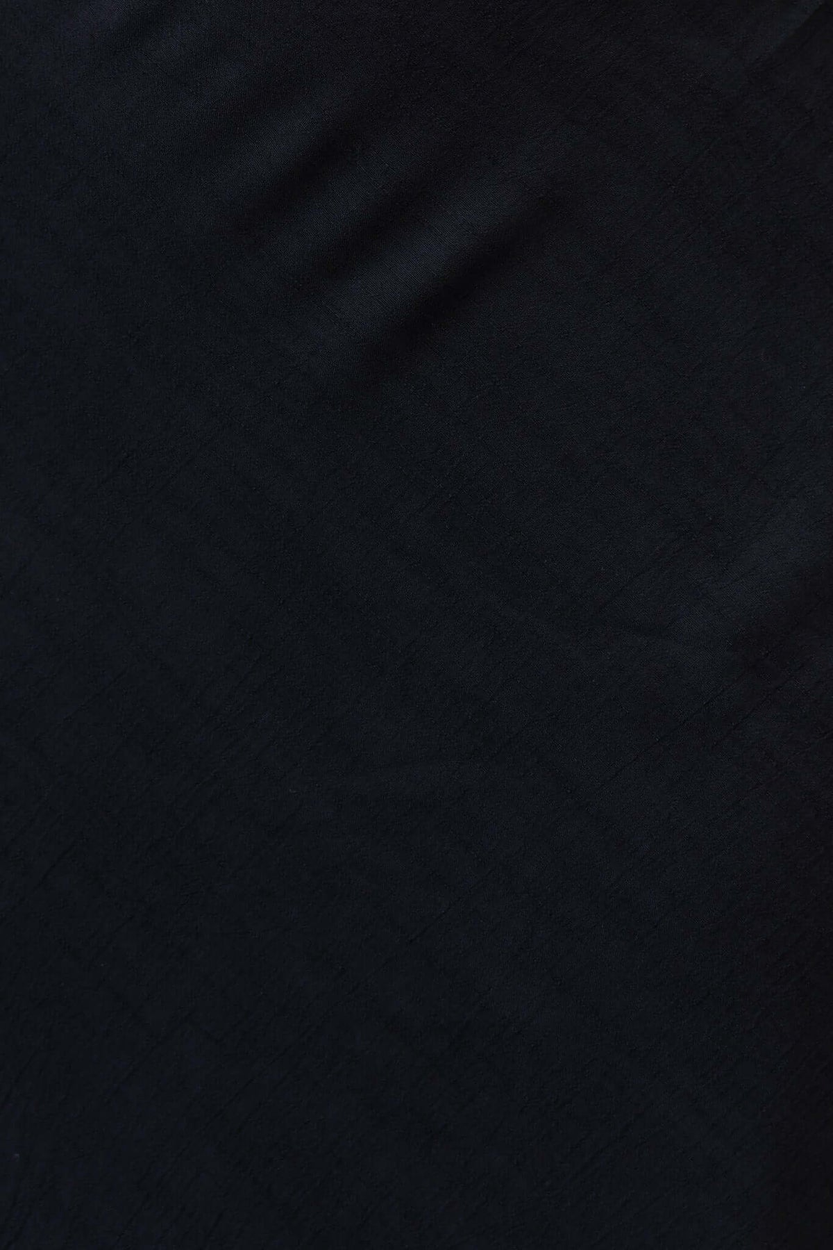 Close-up of black chiffon fabric texture for the Meriden Maxi Skirt, showcasing a smooth and elegant appearance.