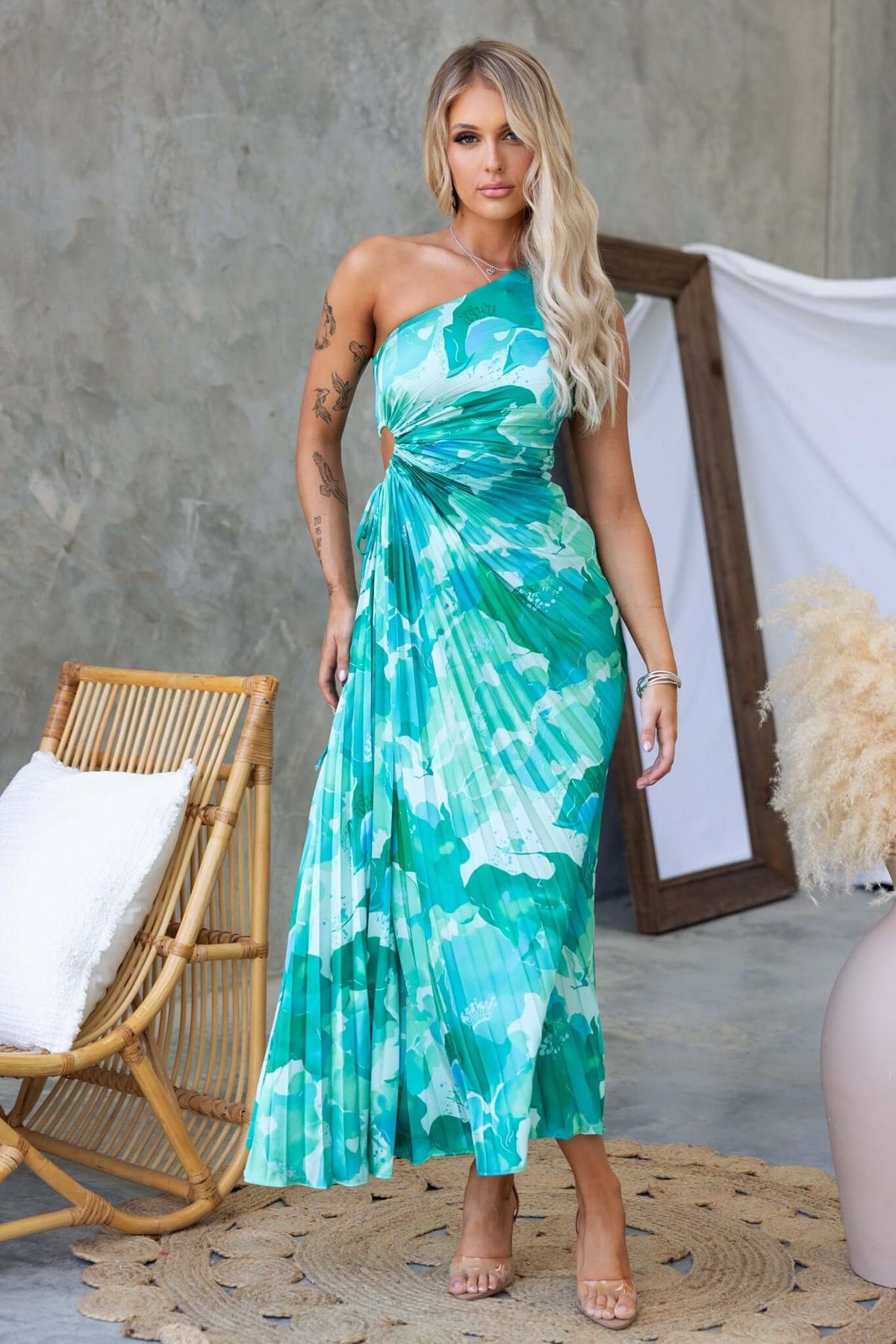 Ottile Maxi Dress in green floral print, featuring one-shoulder design, cut-out waist, and accordion pleat material.