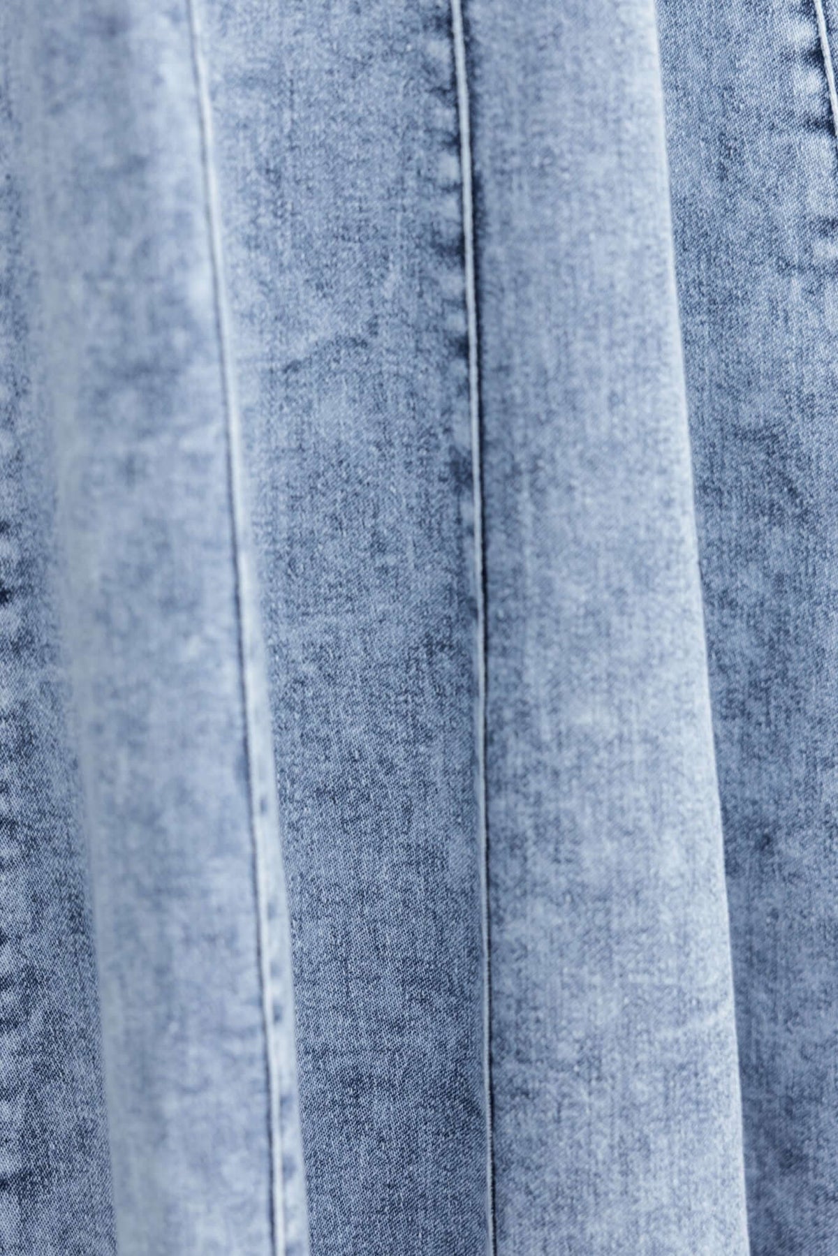 Close-up of Annette Maxi Denim Dress fabric showing light blue denim texture and slight stretch detail.