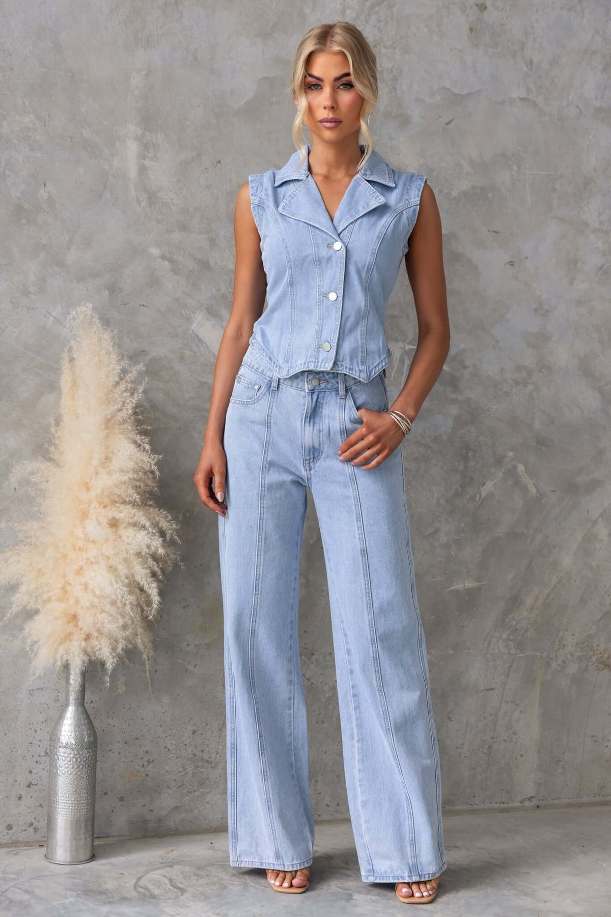 Model wearing Billie Denim Top featuring a collar, button-up front, paired with wide-leg denim pants.