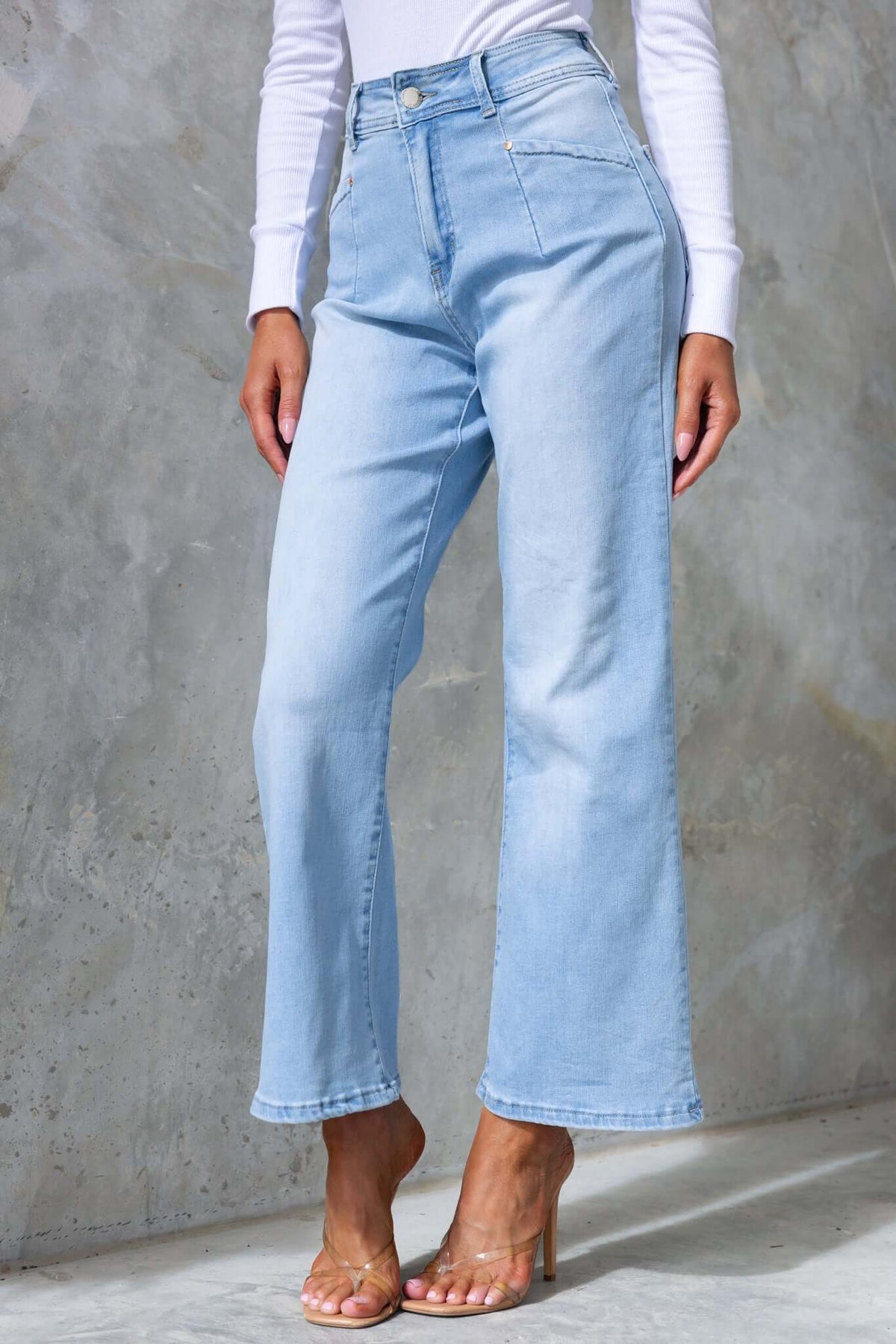 Light blue mid-high waist denim jeans with wide legs and pockets, perfect for casual styling.