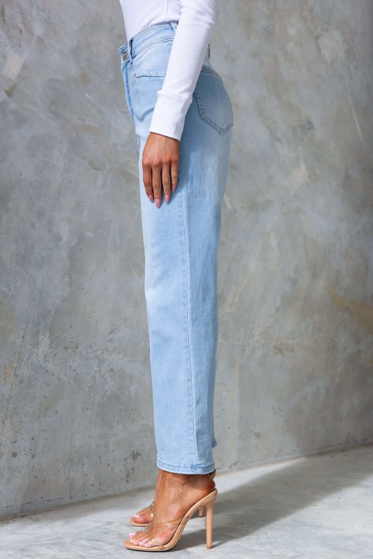Side view of Blanca Jeans featuring a mid-high waist, wide legs, and front and back pockets in light denim.
