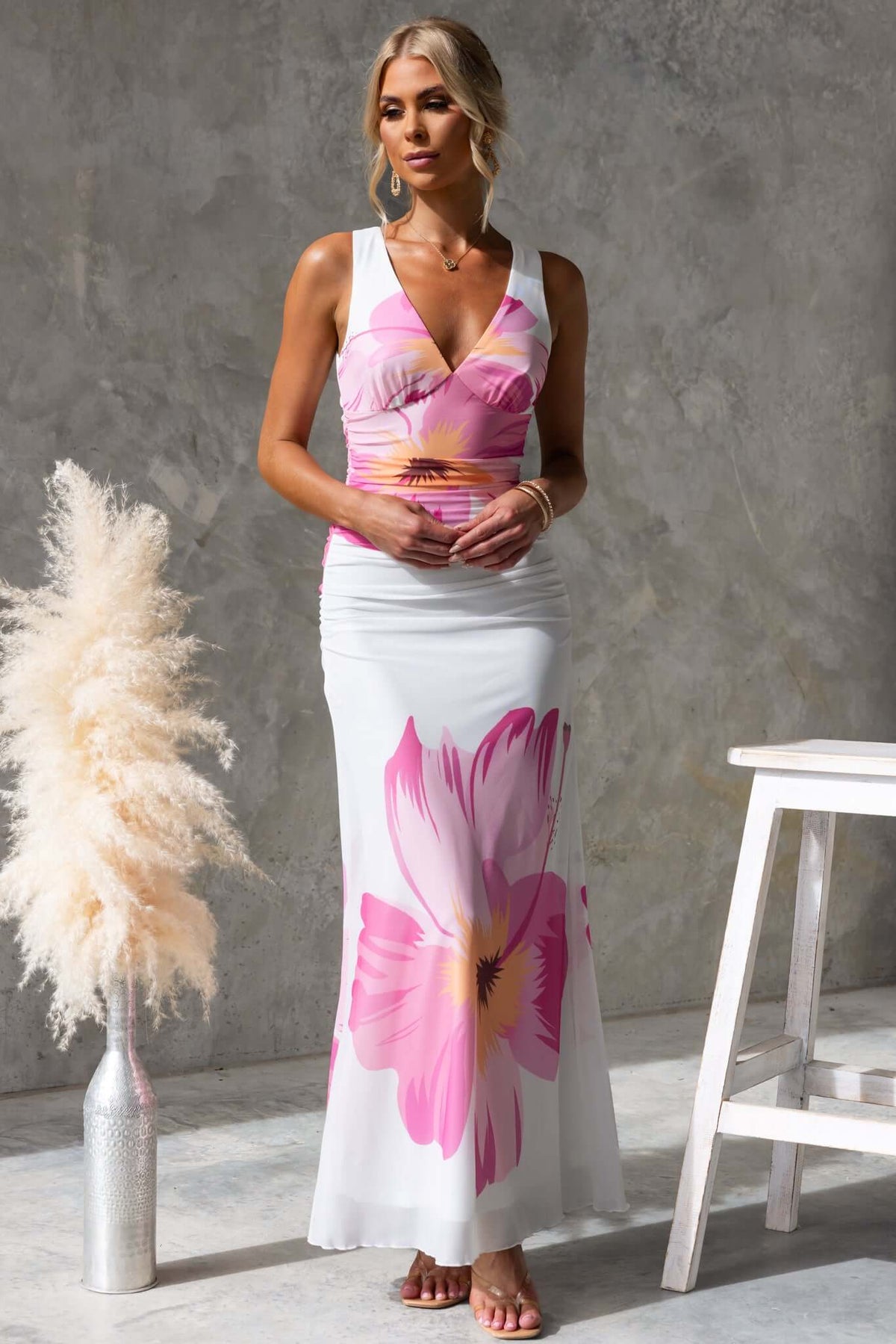 Blax Maxi Dress featuring a floral design, V-neckline, and tie at the back, perfect for summer events.