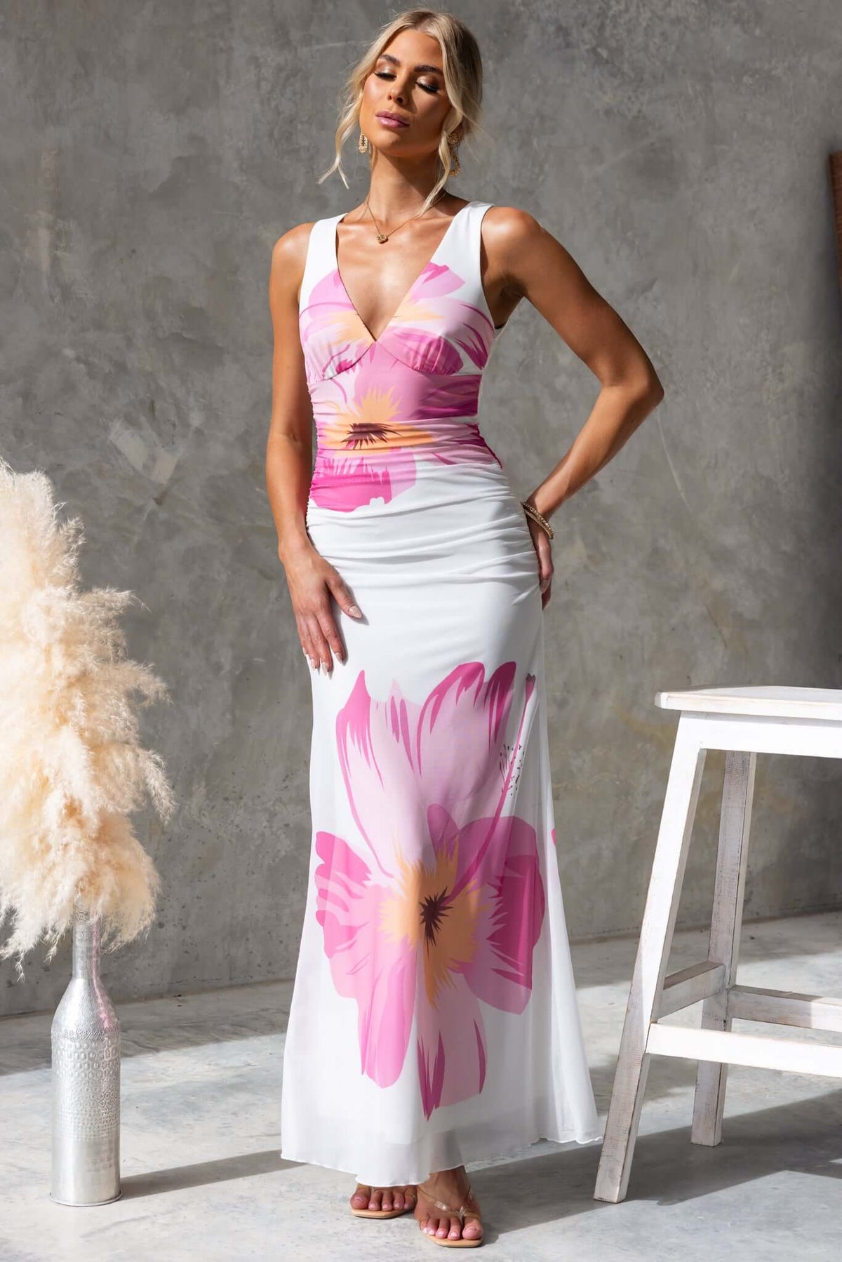 Blax Maxi Dress featuring a V-neckline, side zip, and vibrant floral design, perfect for a stylish summer look.