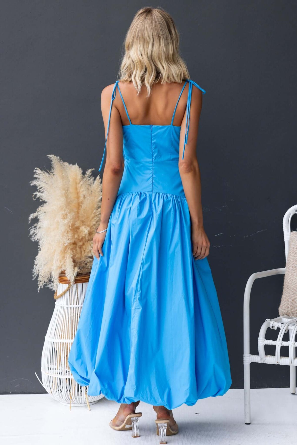 Back view of Bonisa Maxi Dress in blue with tie straps and a flowy silhouette, showcasing its cotton material and lined design.