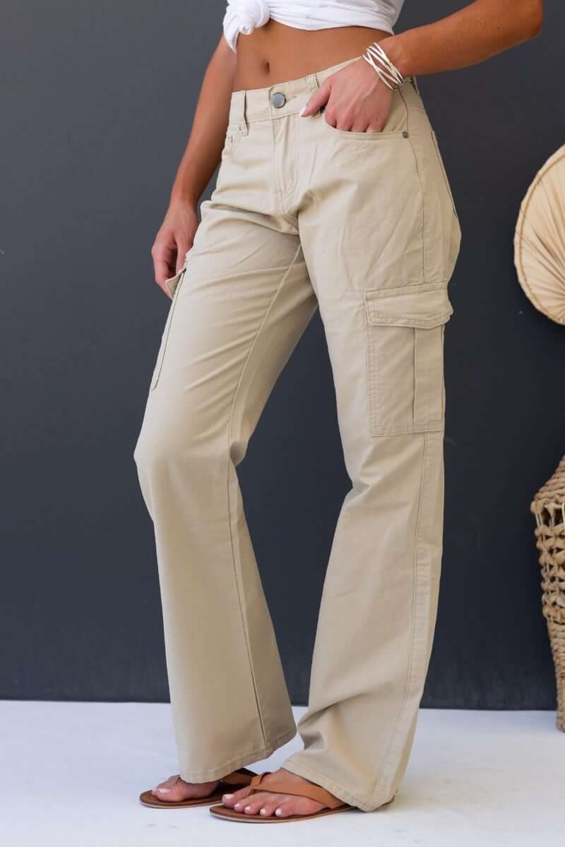 Bowie Cargo Pants in khaki with wide legs and pockets, displayed in a casual outfit for a stylish look.
