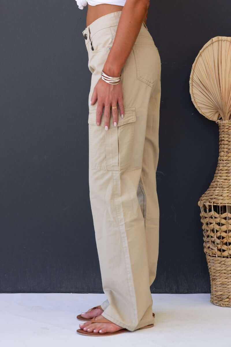 Side view of Bowie Cargo Pants in khaki with wide legs and pockets for a relaxed fit.