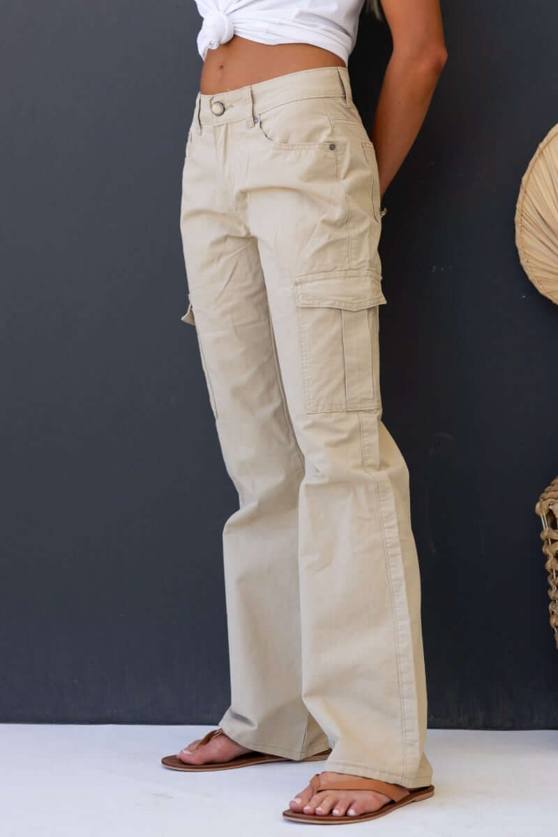 Bowie cargo pants with a low-mid waist fit, wide legs, and multiple pockets, styled by a model.