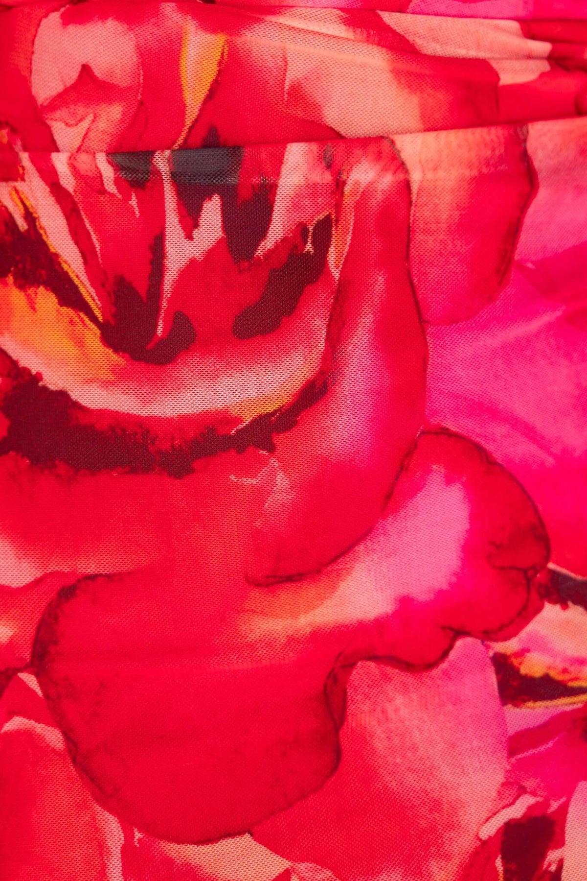 Close-up of vibrant pink floral pattern on Meriden Maxi Dress, showcasing rich colors and smooth fabric texture.