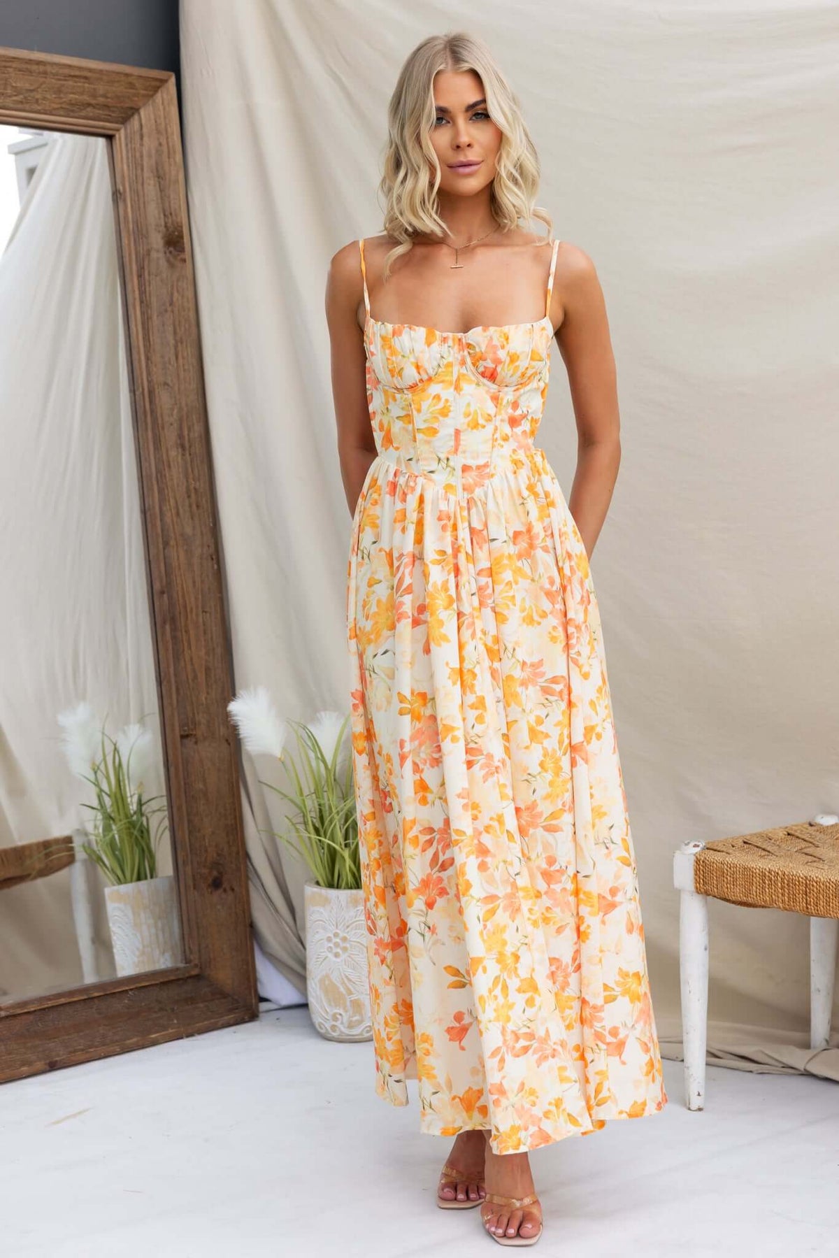 Model wearing a Burkes Midi Dress with floral patterns, adjustable straps, and a comfortable fit.
