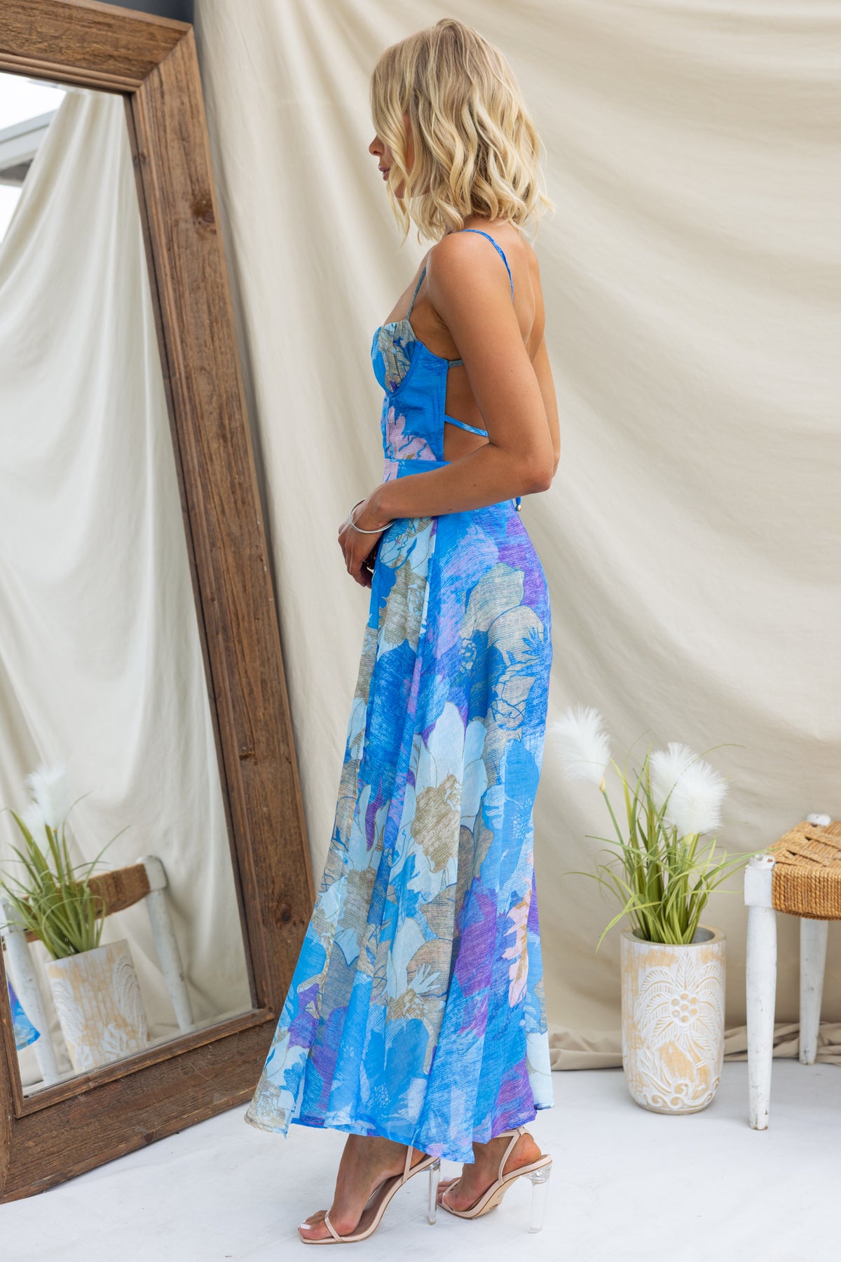 Burkes Midi Dress in blue floral print, featuring adjustable tie straps and a stylish side view display.