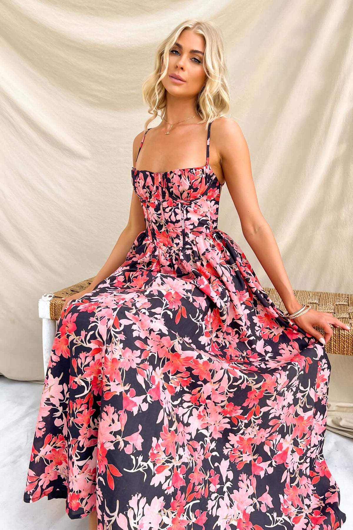 Model wearing Burkes Midi Dress with floral pattern, adjustable straps, and flattering skirt. Perfect for summer outings.