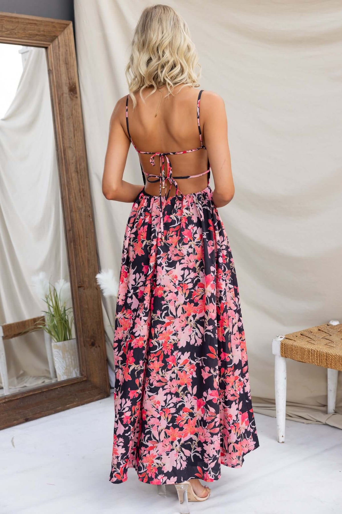 Back view of Burkes Midi Dress with floral pattern, adjustable tie straps, and open back design.