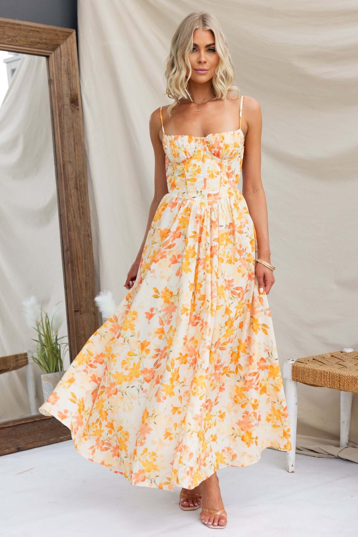 Burkes Midi Dress in floral pattern with adjustable tie straps and flowing silhouette, perfect for summer occasions.