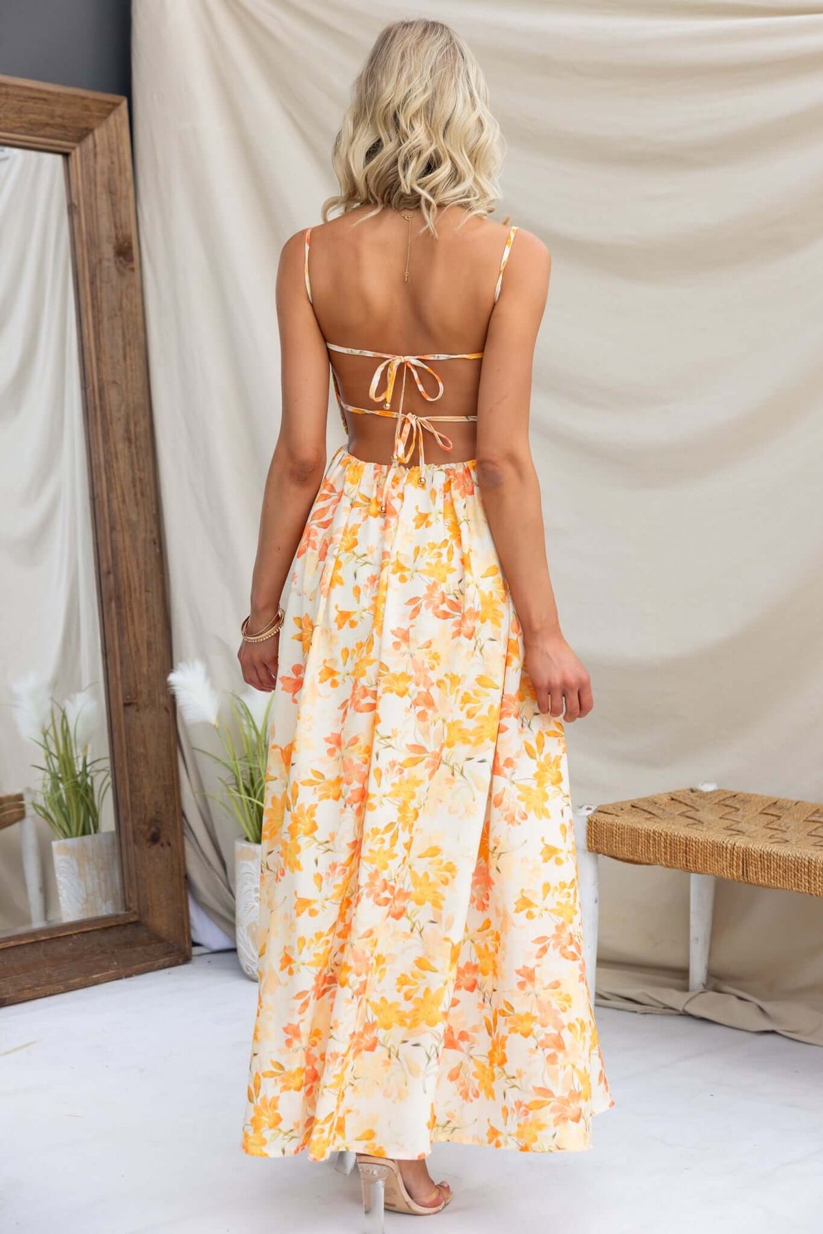 Back view of Burkes Midi Dress featuring adjustable tie straps and floral print, perfect for summer styling.