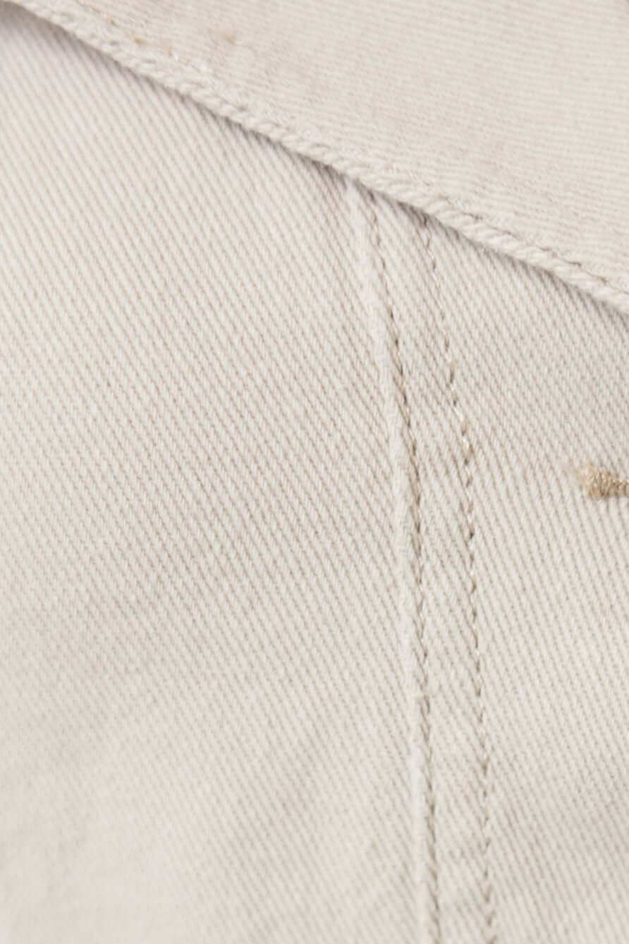 Close-up of textured cotton fabric showing stitching details, perfect for denim shorts.