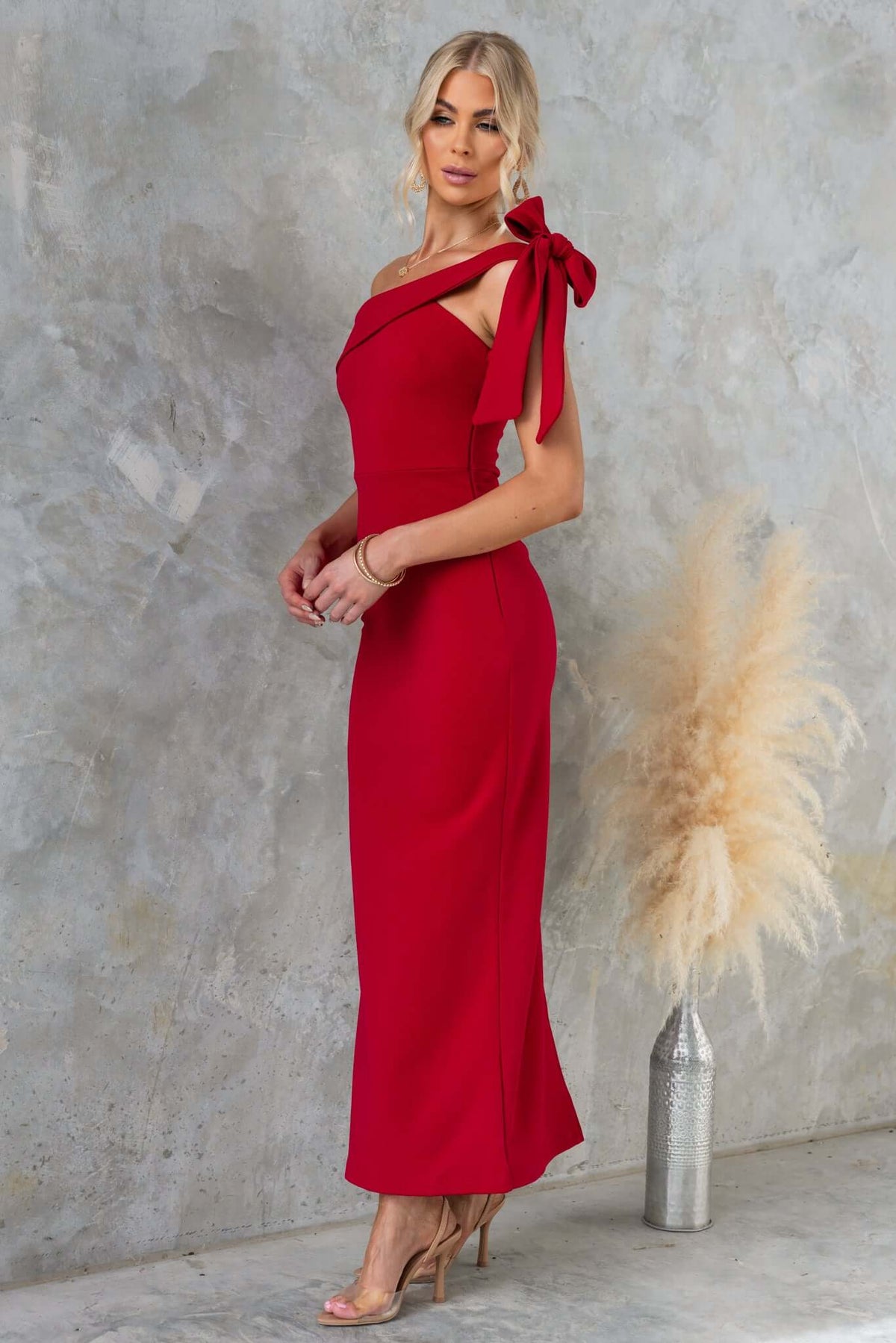 Devon Midi Dress in red with asymmetric neckline and tie detail, featuring a side zip and split back, perfect for elegant occasions.