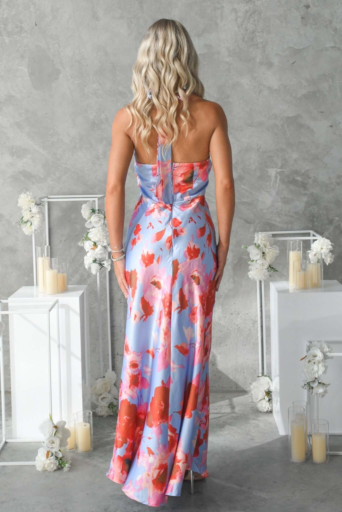 Back view of the Forbidden Love Maxi Dress featuring a floral design and high tie neckline, ideal for formal occasions.