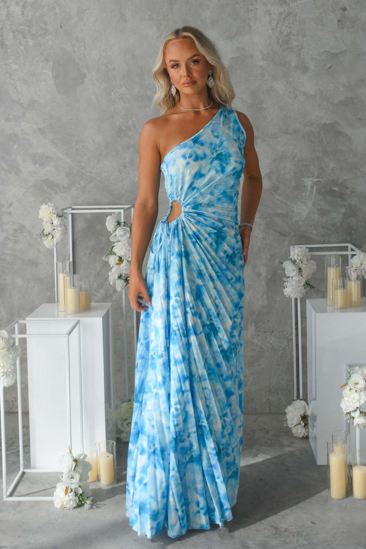 Blue tie-dye Tejano maxi dress featuring one-shoulder neckline, cut-out waist, and accordion pleat material.