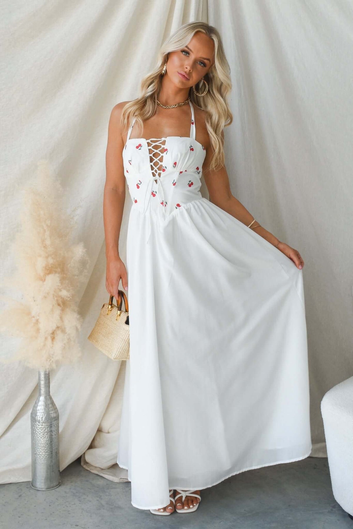 Serefina Maxi Dress in white with tie straps, boning at bust, and embroidered details, perfect for summer outings.