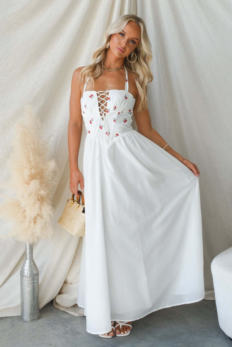 Serefina Maxi Dress in white with tie straps, boning at bust, and embroidered details, perfect for summer outings.