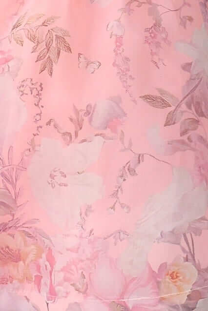 Floral design on soft pink fabric, featuring delicate blossoms and intricate patterns.