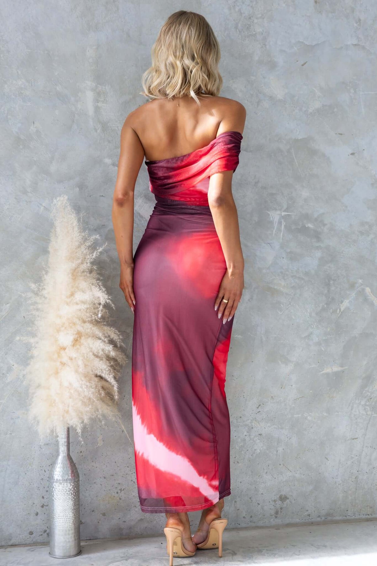 Eccentric maxi dress with one-shoulder neckline in red gradient, showcasing a sleek fit and mesh material.