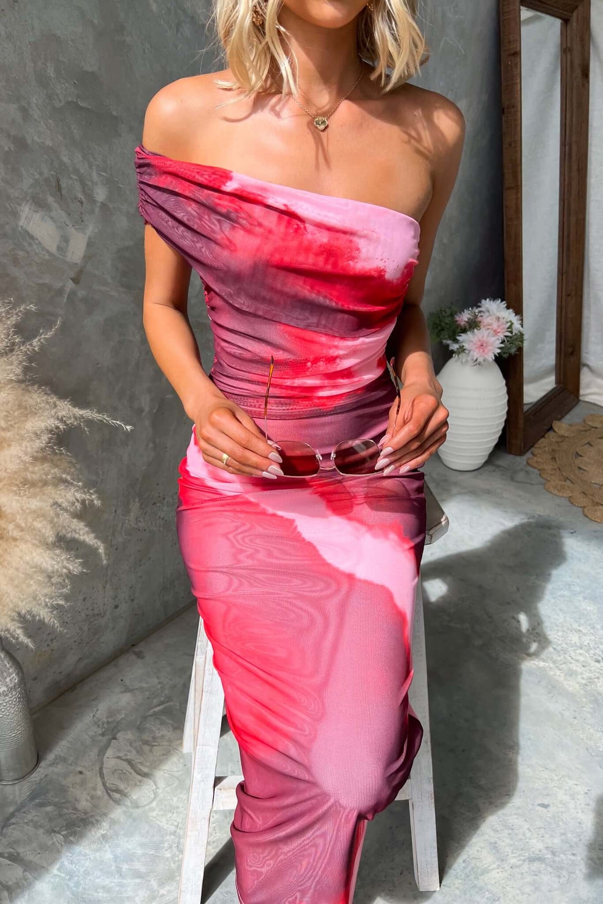 Eccentric maxi dress with one-shoulder neckline, stretch mesh material, and vibrant pink gradient pattern.