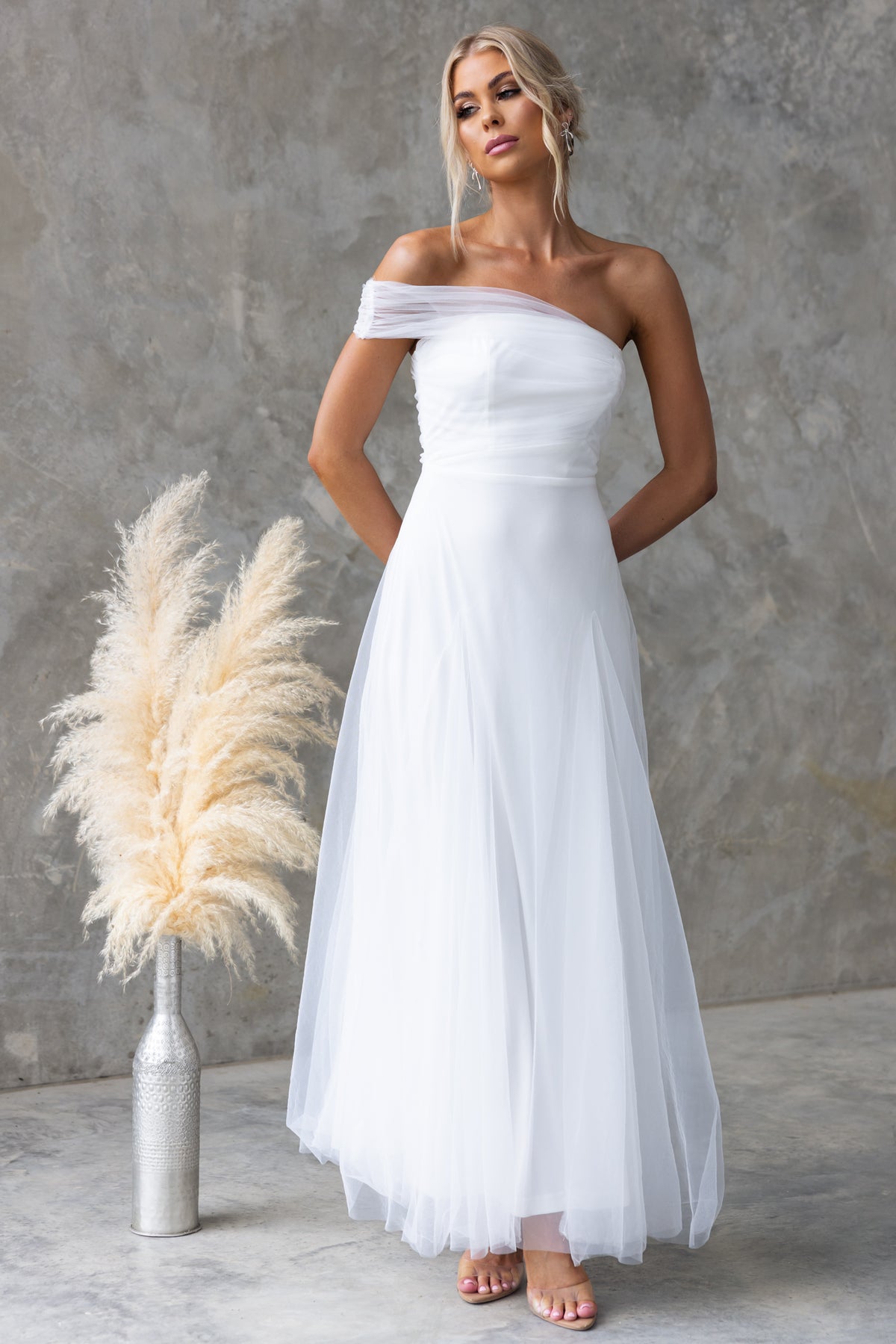 Elegant Eleah Maxi Dress with one-shoulder neckline in tulle, perfect for bridal occasions. Model in size 6/XS.