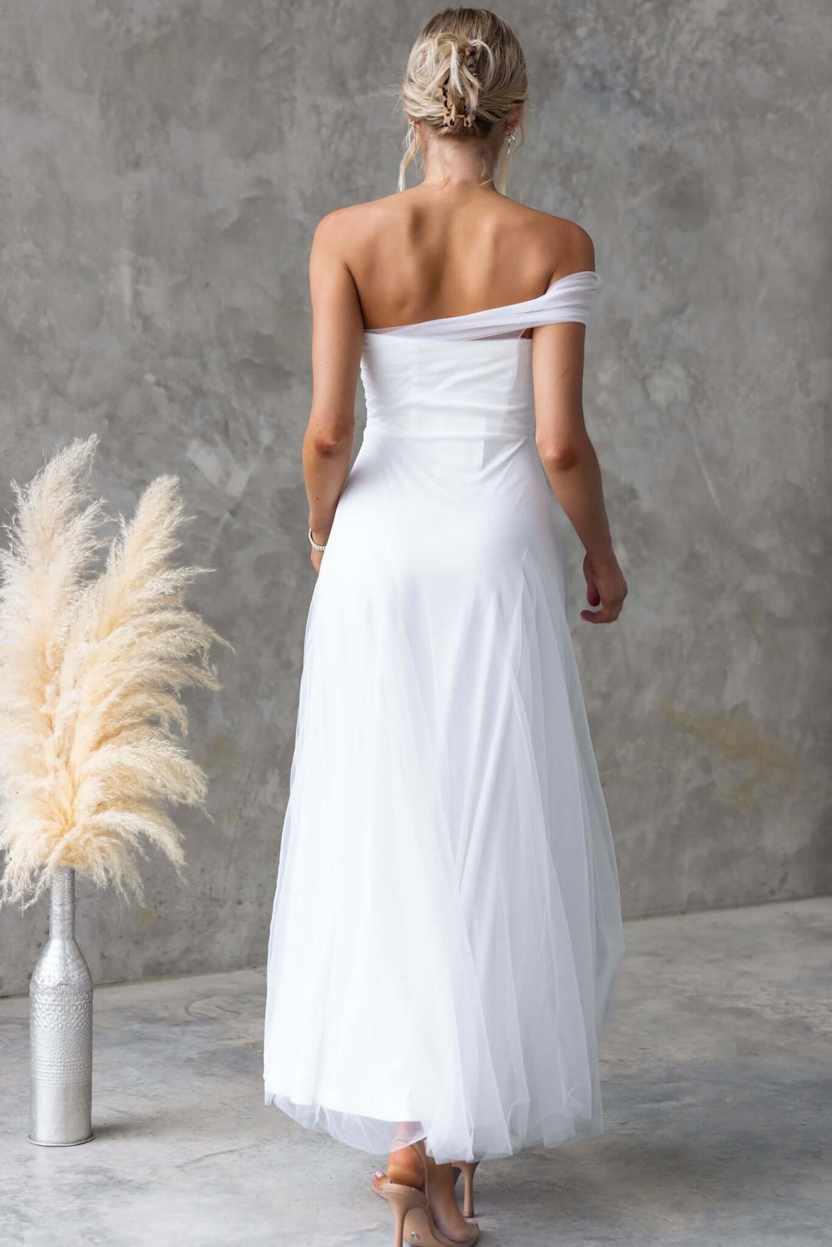 Back view of Eleah Maxi Dress with one-shoulder neckline in soft white tulle, showcasing elegant design and fit.