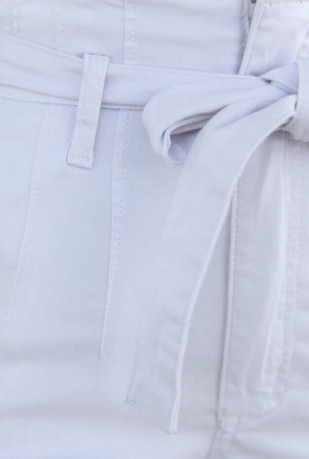 Close-up of the removable fabric belt on New Hope high-waist paper bag jeans in white denim.