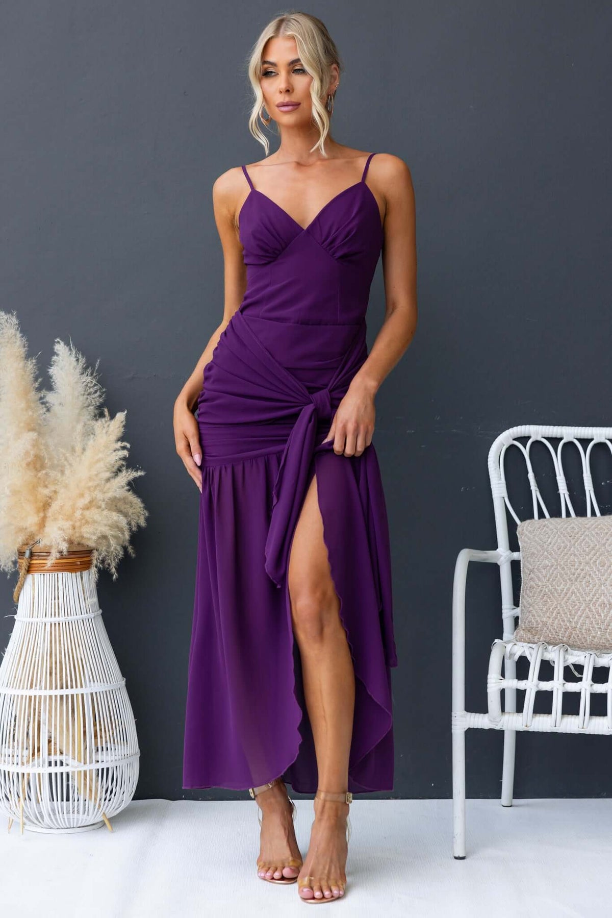 Elegant purple iconic maxi dress with adjustable straps and front split, styled for summer fashion.