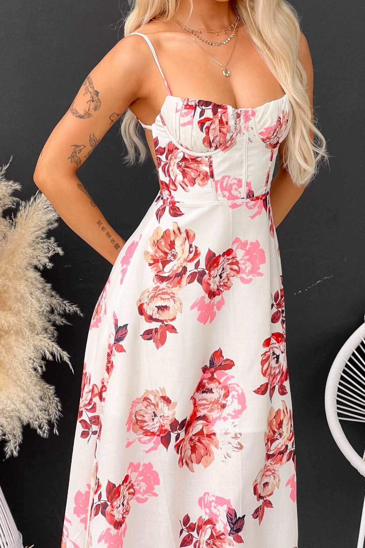 Burkes Midi Dress featuring floral print, adjustable tie straps, and a front split, modeled by a woman.
