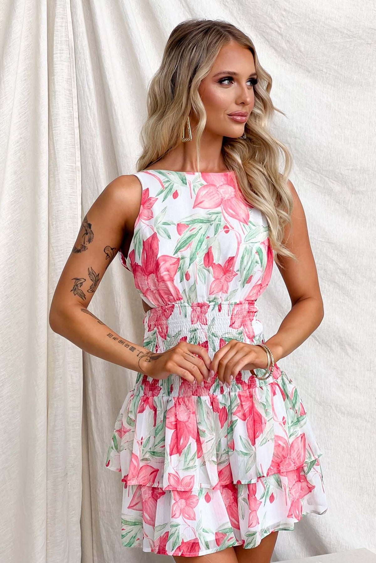 Ameera Dress: Floral-patterned sleeveless dress with high neckline, tie back detail, and layered skirt, perfect for summer.