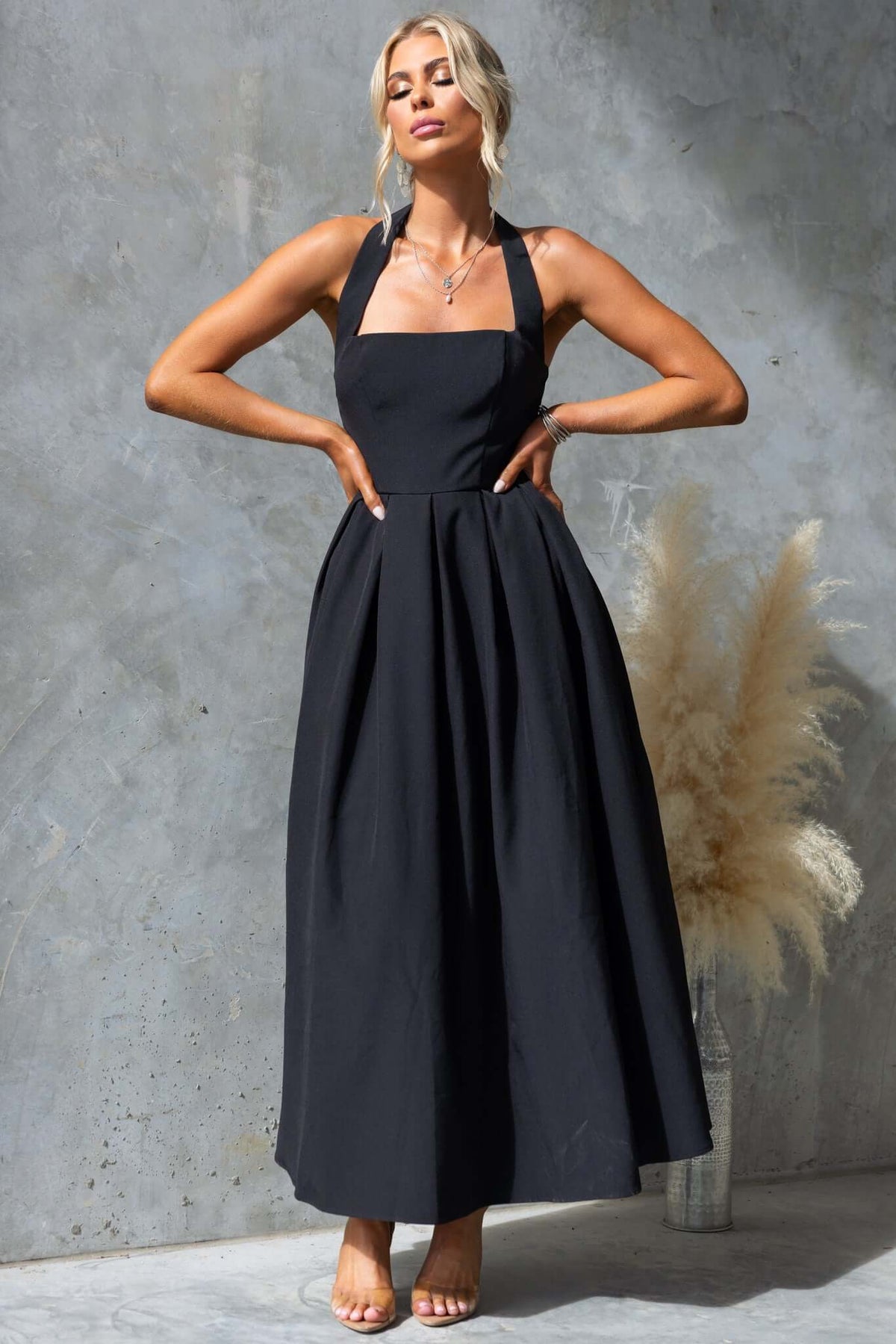 Jhene Maxi Dress in black, featuring a square neckline, halter straps, and a flowing silhouette, perfect for stylish occasions.