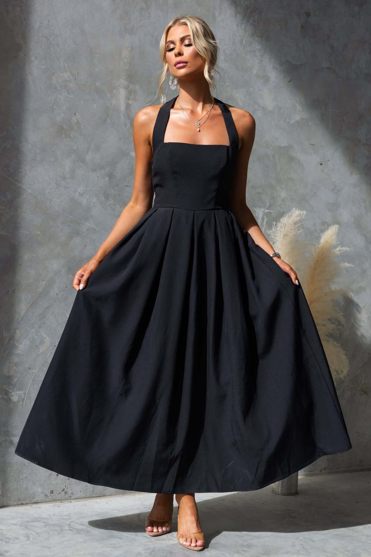 Jhene Maxi Dress in black, featuring a halter neck and flowy skirt, perfect for summer occasions.