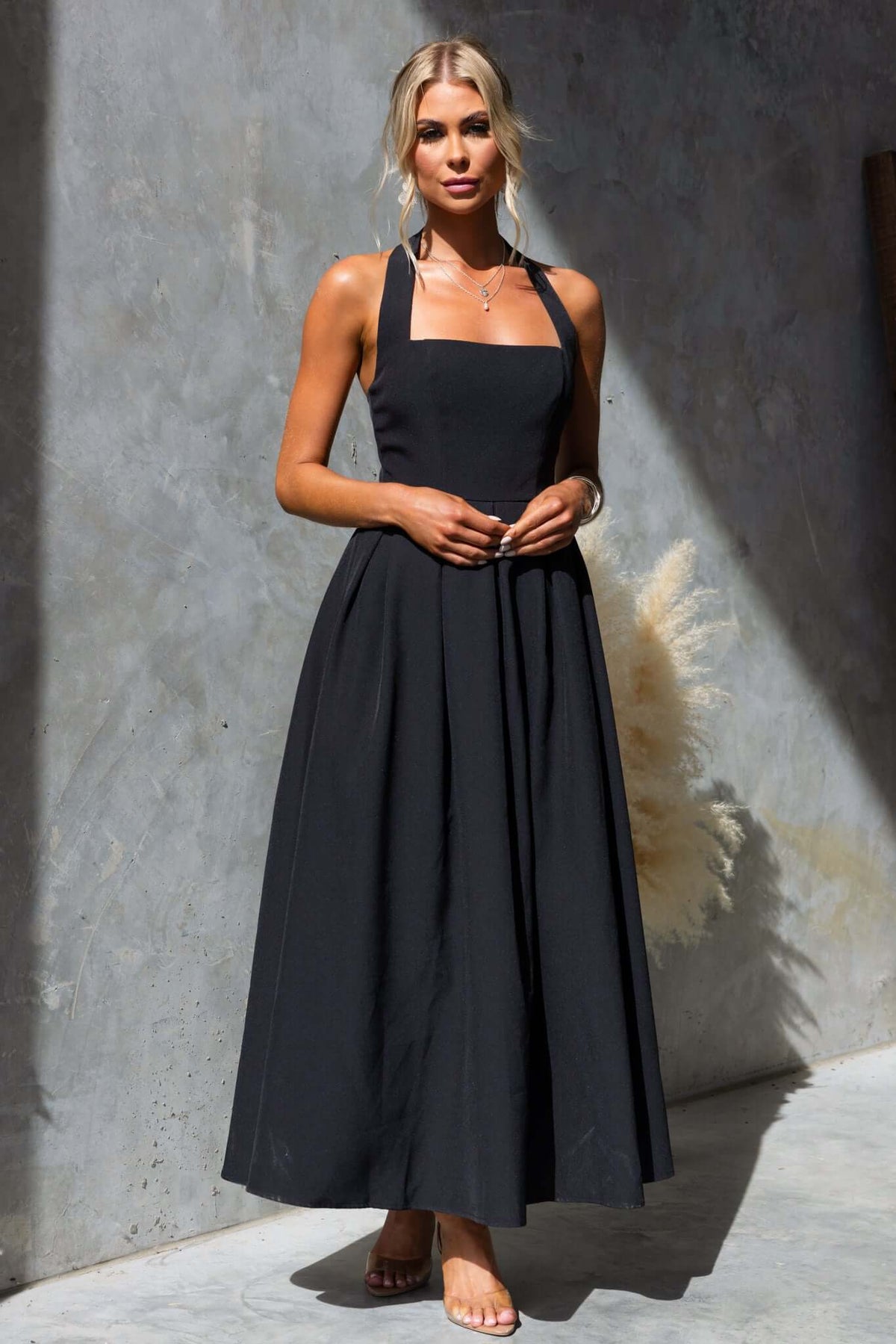 Jhene Maxi Dress: Black halter neck maxi dress with a fitted bodice and flowing skirt, perfect for stylish occasions.