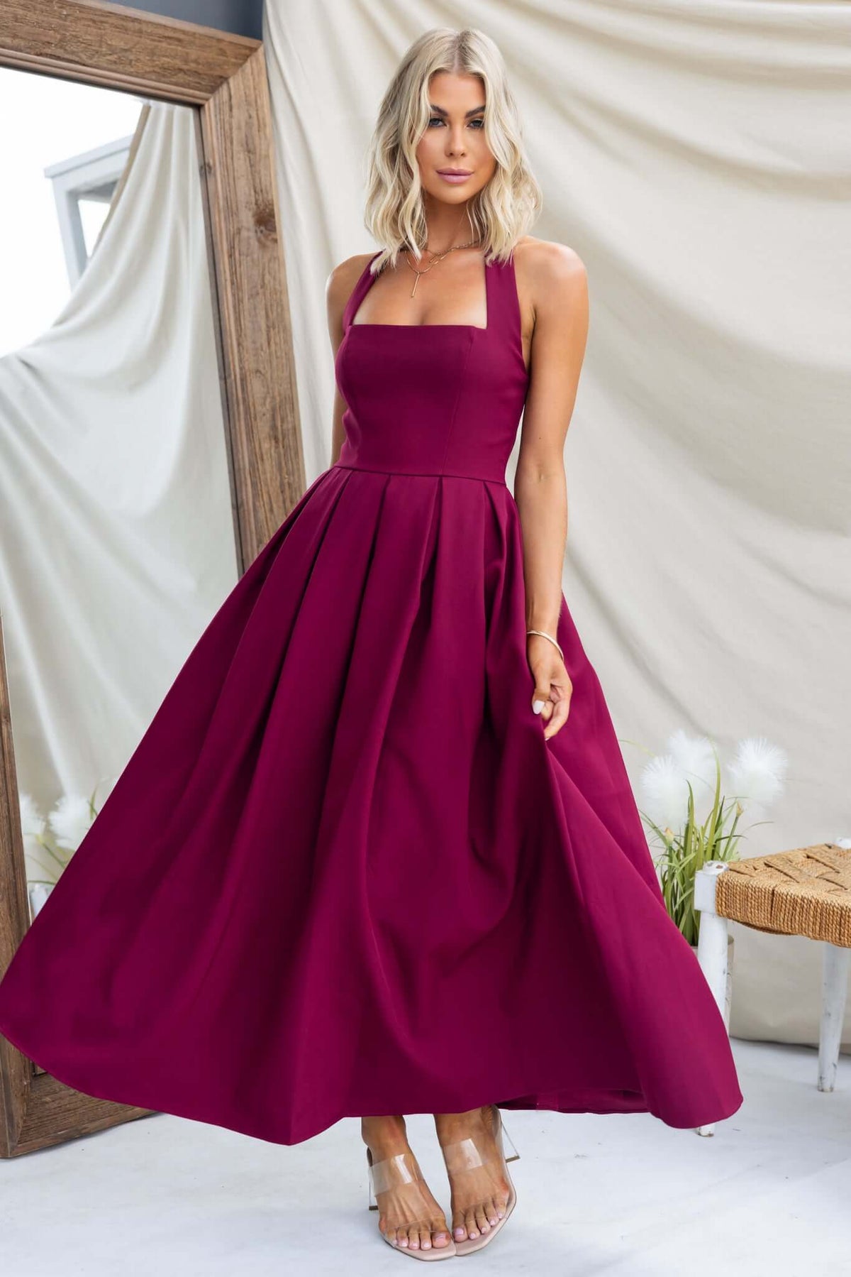 Jhene Maxi Dress in burgundy, featuring a halter neck and flowy skirt, perfect for elegant occasions.