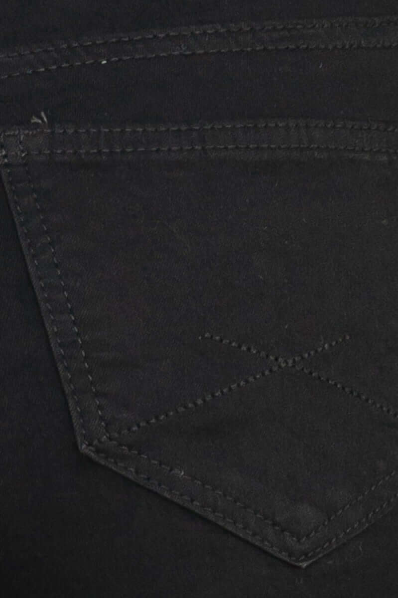 Close-up of black Justified Jeans pocket with stitching details, showcasing mid-high waist fit and firm stretch fabric.