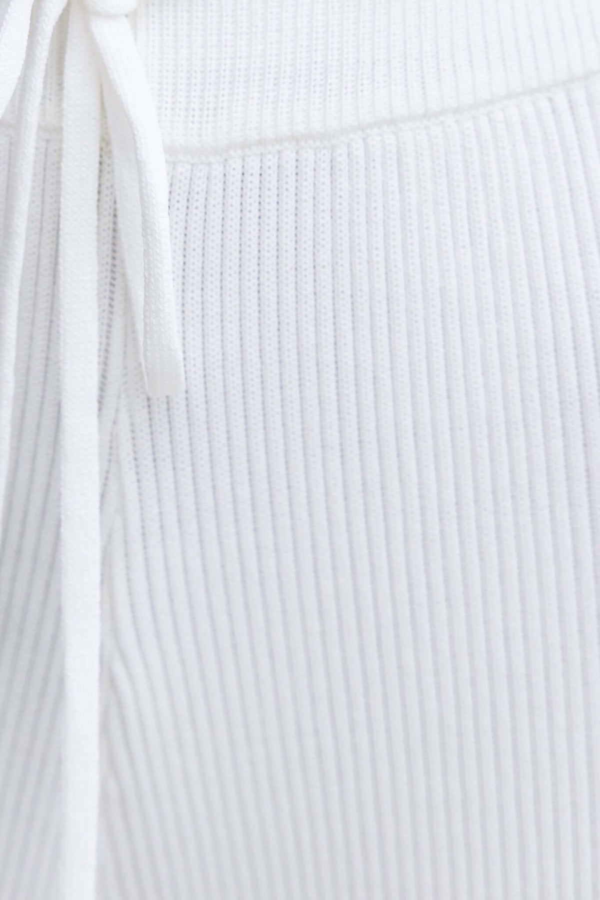 Close-up of Keene Pants showing mid-high waist, ribbed knit material, and drawstring elastic waistband.