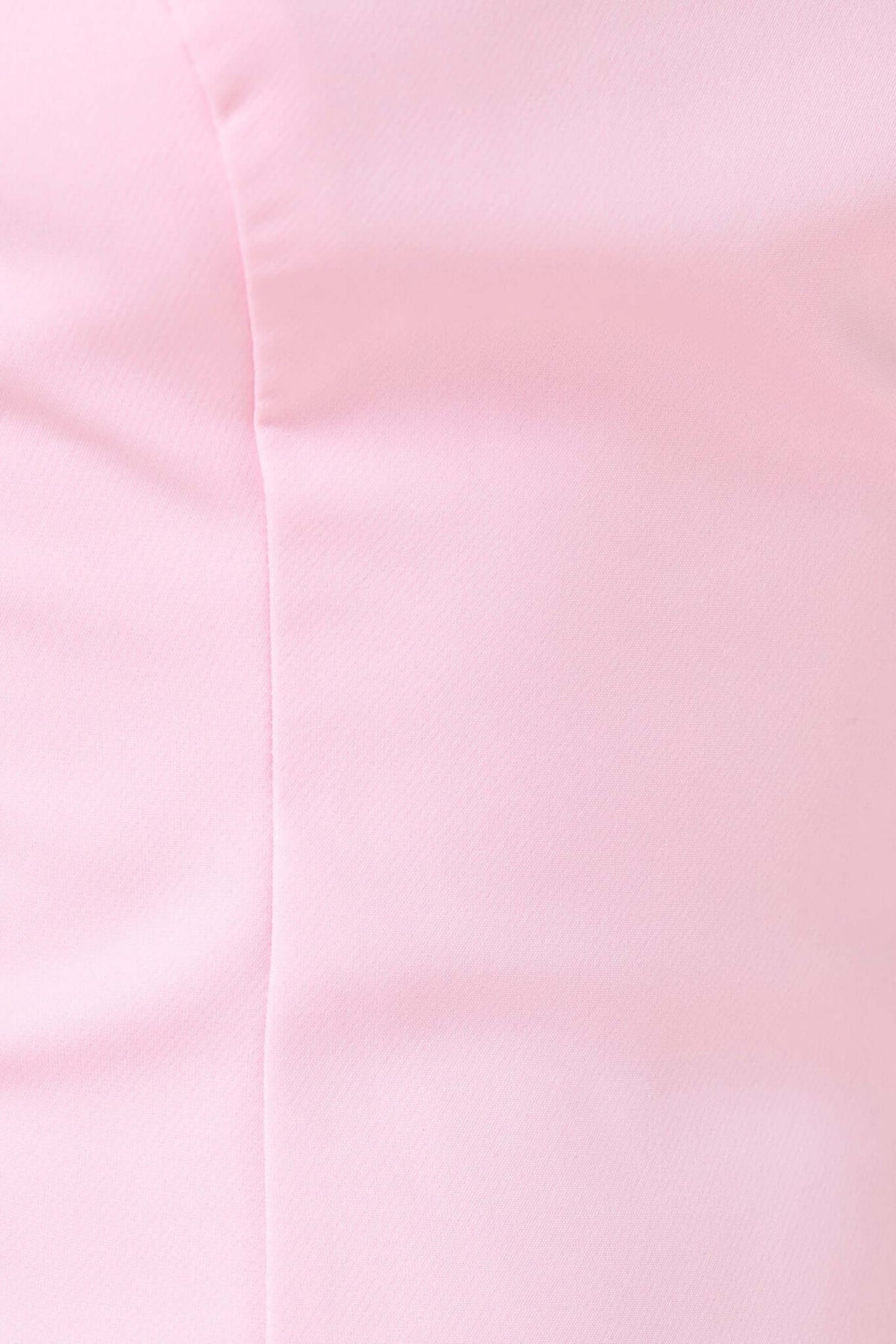 Close-up of soft pink fabric texture of Kenna Dress, showcasing its smooth polyester material.