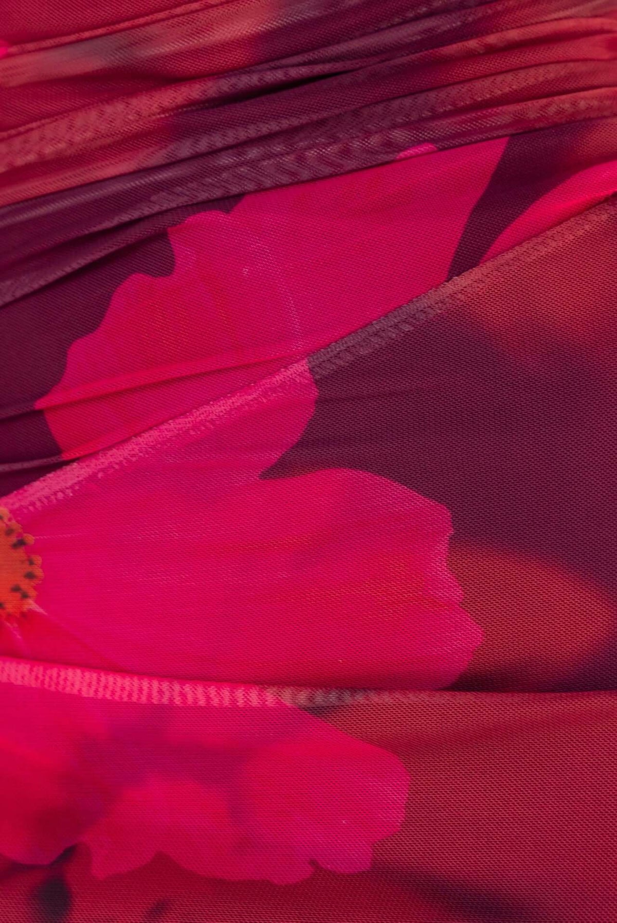 Close-up of the Korren Maxi Dress featuring vibrant pink floral mesh fabric and textured detailing.