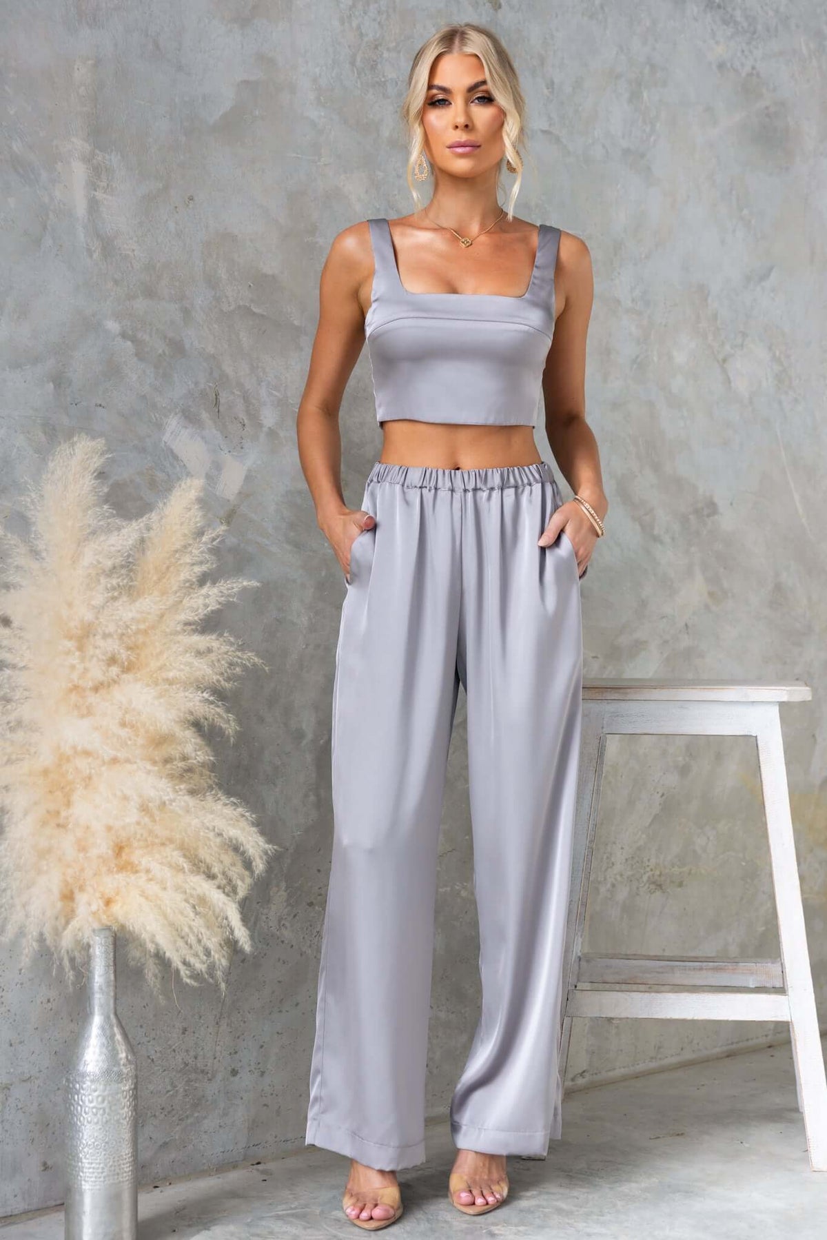 Model wearing Kortez Pants in satin, mid-high waist with pockets, paired with a matching crop top, stylish and comfortable.
