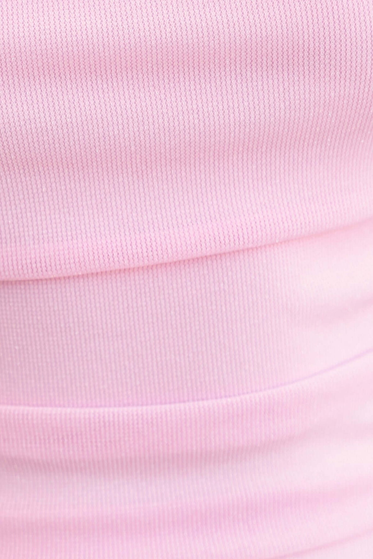 Close-up of textured pink fabric showcasing stretch material for the Legrand Maxi Dress.