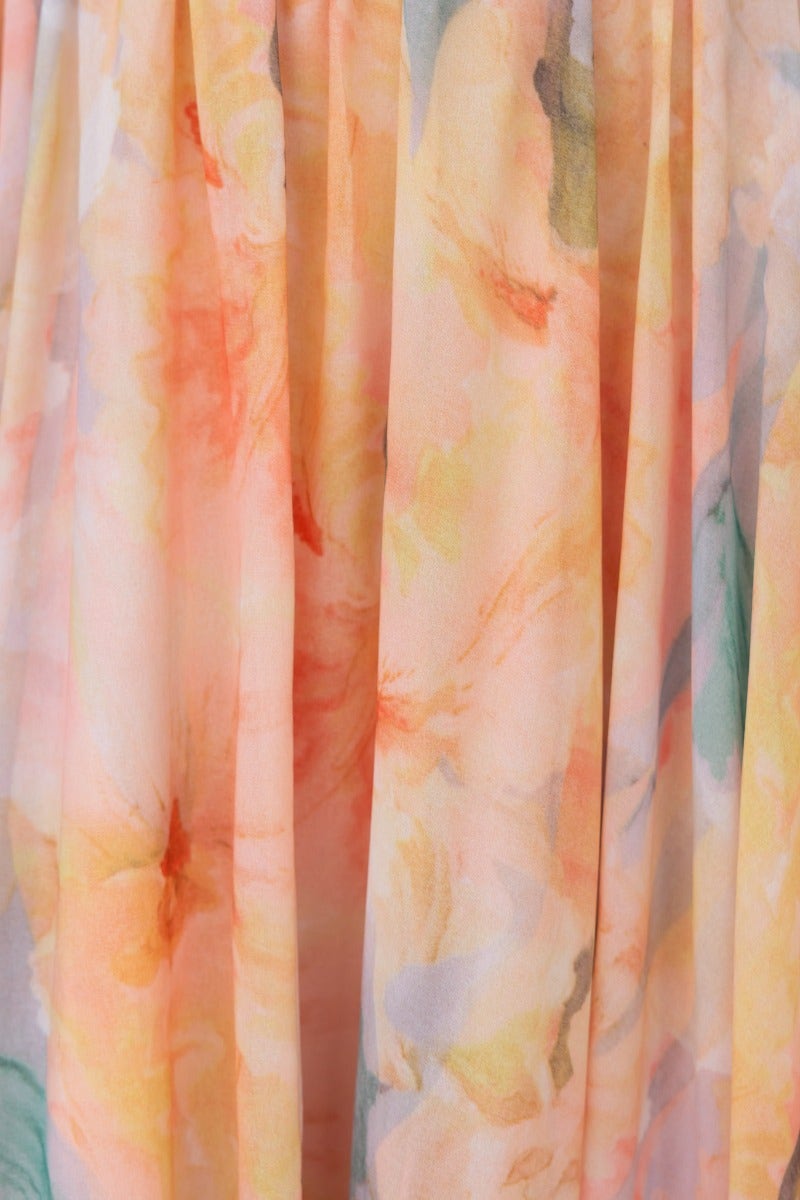 Close-up of the floral fabric of the Little Things Maxi Dress, showcasing soft pastel colors and delicate print.