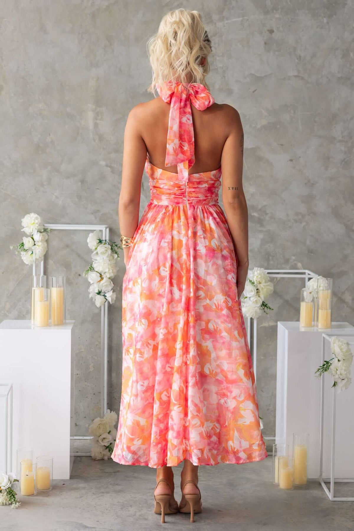 Rear view of the Little Things Maxi Dress showcasing high tie neckline and floral pattern, perfect for summer events.