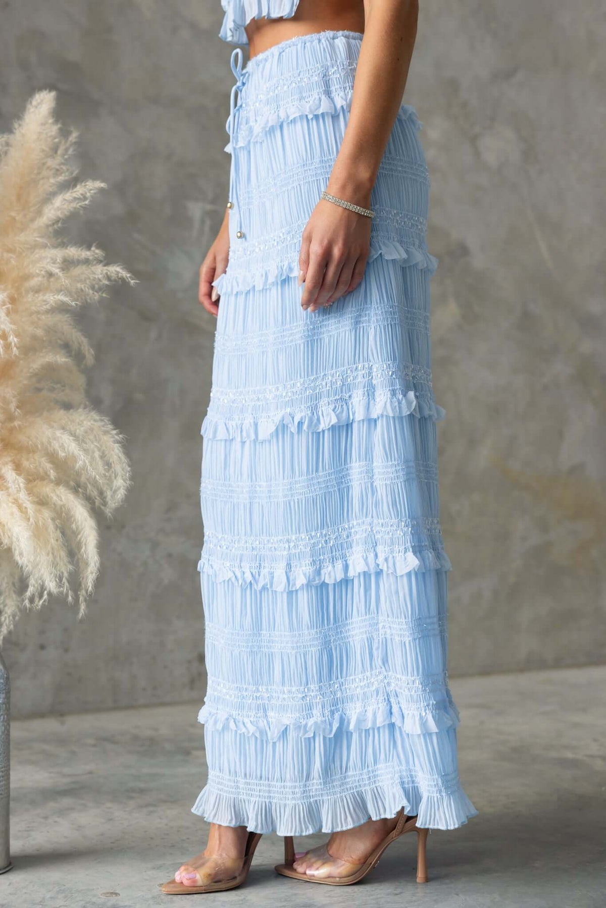 Lolana Maxi Skirt in light blue with ruffles and drawstring, showcasing mid-high waist and elegant design.