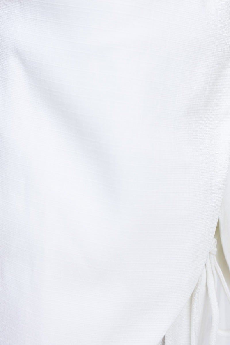 Close-up of soft, textured white fabric showcasing details of the Long Shot Pants' design and fabric quality.